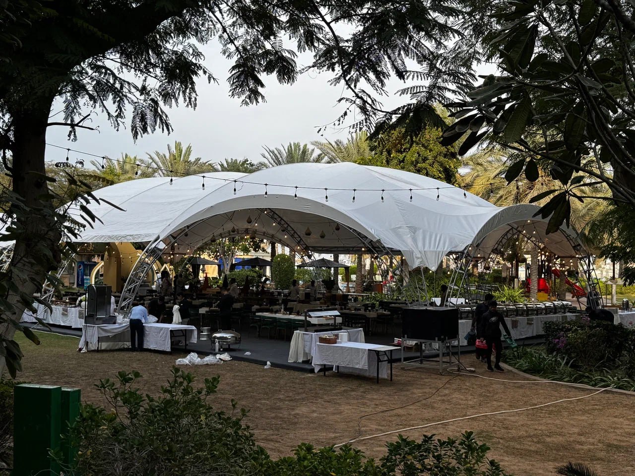 Spacious Ramadan tent setup for community iftar dinner with guests seated at tables