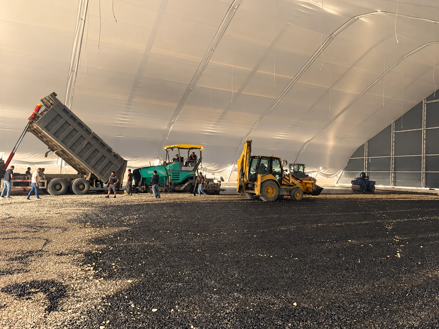 Editorial adaptation of construction machinery carrying out groundworks inside a fabric cover.