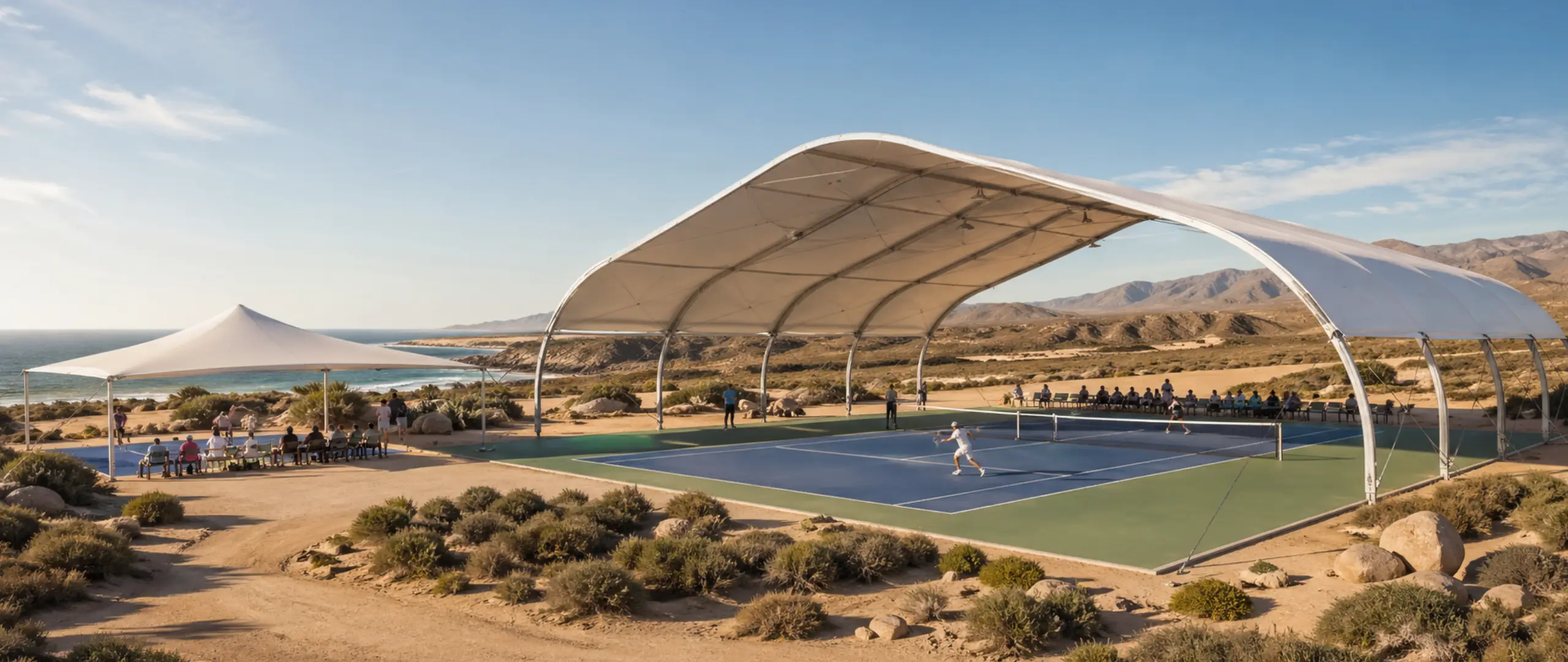 Premium tennis court tent in Dubai with clear-span arch roof, open sides and a professional court underneath