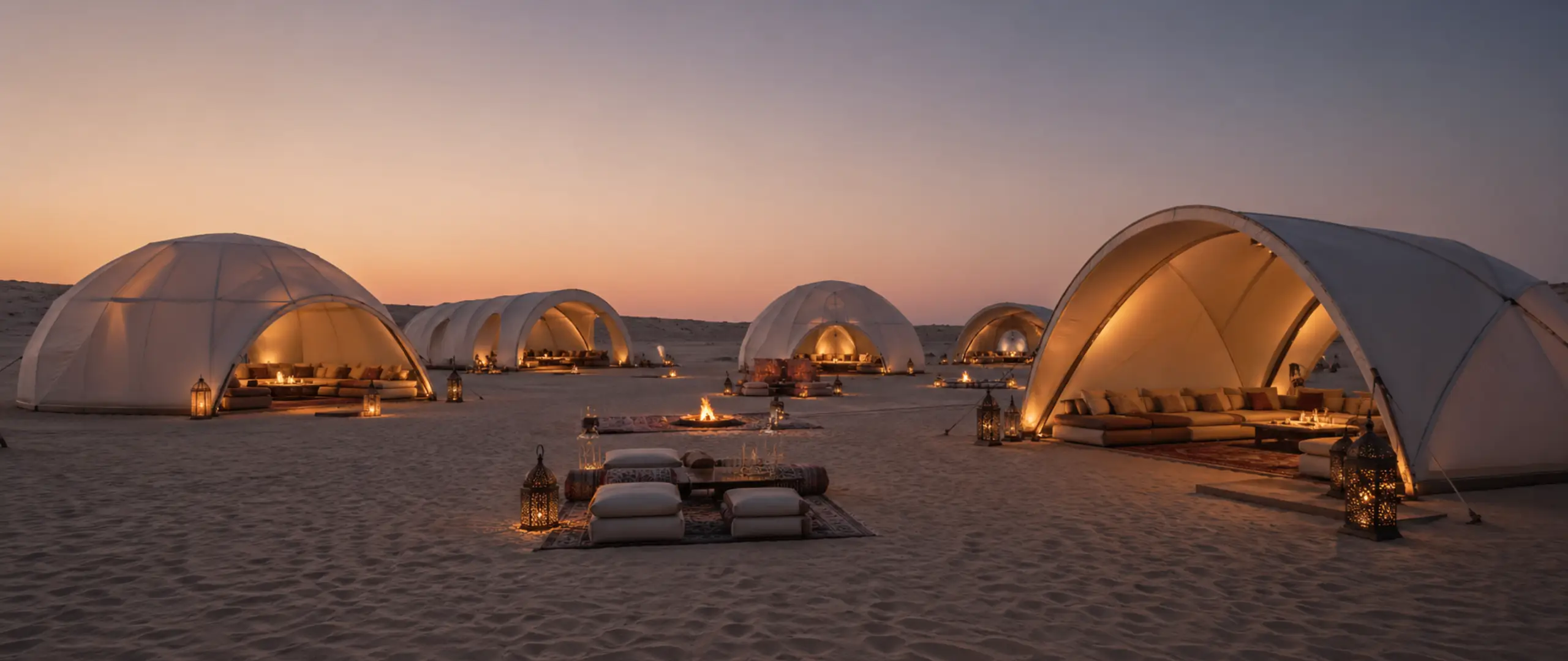 Multiple majlis tent structures in UAE desert including dome and arch tents with clear-span design and different sizes
