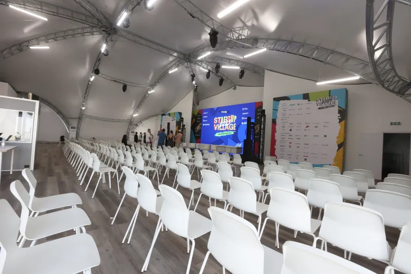 Conference seating and stage inside the completed StartUp Village tent at Skolkovo.