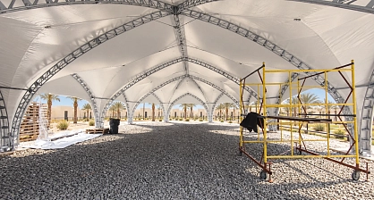 Arch trusses and assembly scaffold inside the restaurant tent