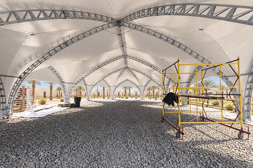 Arch trusses and assembly scaffold inside the restaurant tent