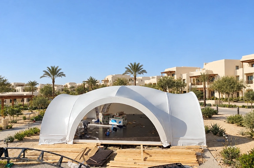 Hotel restaurant arch tent with an open entrance during assembly