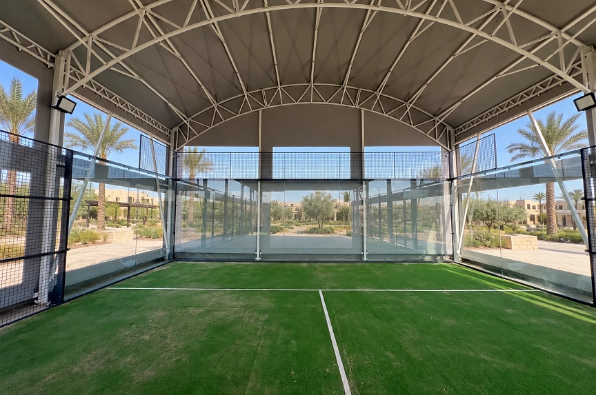 White roof trusses above the padel court