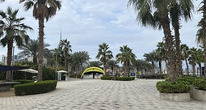 Modular arch tent for Mira Run Dubai marathon event integrated into Dubai Design District landscape with palm trees and modern architecture backdrop