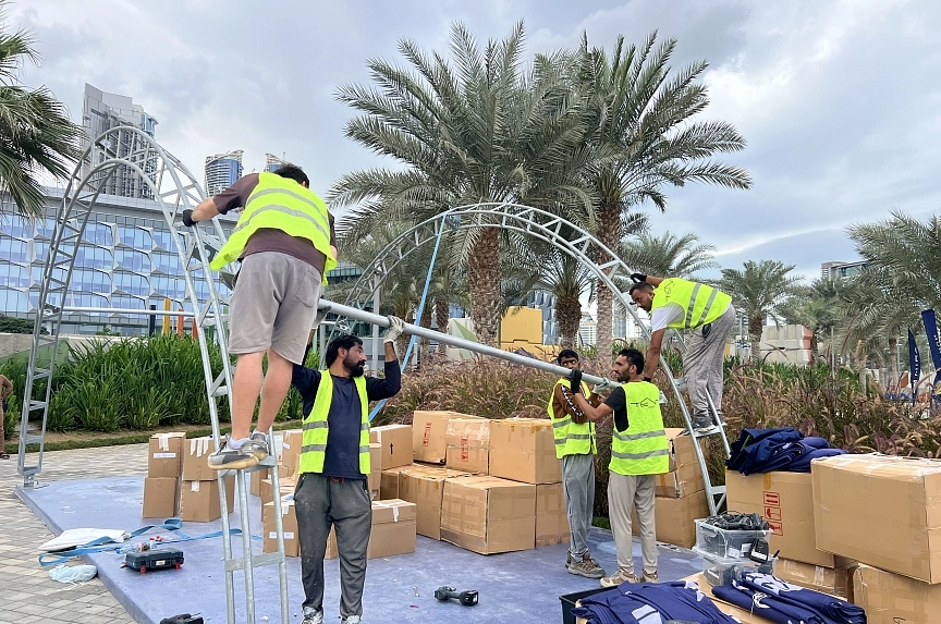 A professional installation crew dismantles the metal structure and exhibition covering for the TentProject modular arch system at the event venue in Dubai's Palm Design District following the conclusion of Mira Run 2025